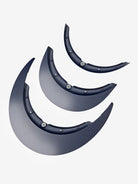 Set of three black fender extensions on a light gray background