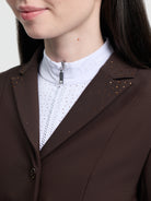 Brown blazer with decorative studs worn by a person, white shirt underneath