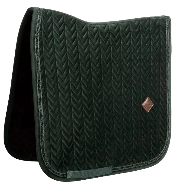 A dark forest green quilted horse saddle pad with a textured chevron pattern and a small brown diamond logo on the front, shown on a plain white background.