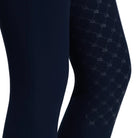 Close-up of dark navy leggings with a subtle tonal diamond lattice pattern on the upper leg, shown against a light gray background.