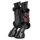 A pair of black leather horse boots with black faux-fur trim and burgundy straps, shown on a light gray background.
