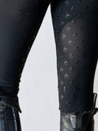Black textured leggings with a pattern on a white background