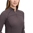 A close-up of a woman wearing a dark brown textured quarter-zip pullover, showing the collar, zipper, and chest panel details against a plain white background.