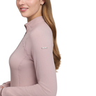 A woman wearing a long-sleeve, ribbed knit quarter-zip pullover in a dusty rose pink color, shown from a side profile against a solid white background. A small white rectangular brand tag on the upper sleeve reads 'Lelouch'.