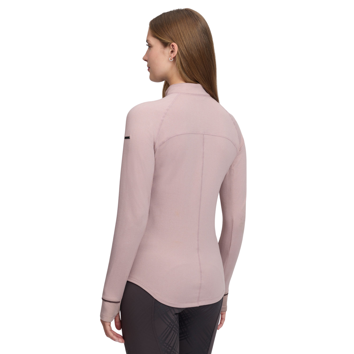 A woman shown from the back wearing a fitted long-sleeve athletic top in a dusty pink color, paired with dark gray leggings, against a plain white background.