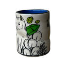 Ceramic mug with a white cat holding green crystals design on a plain background