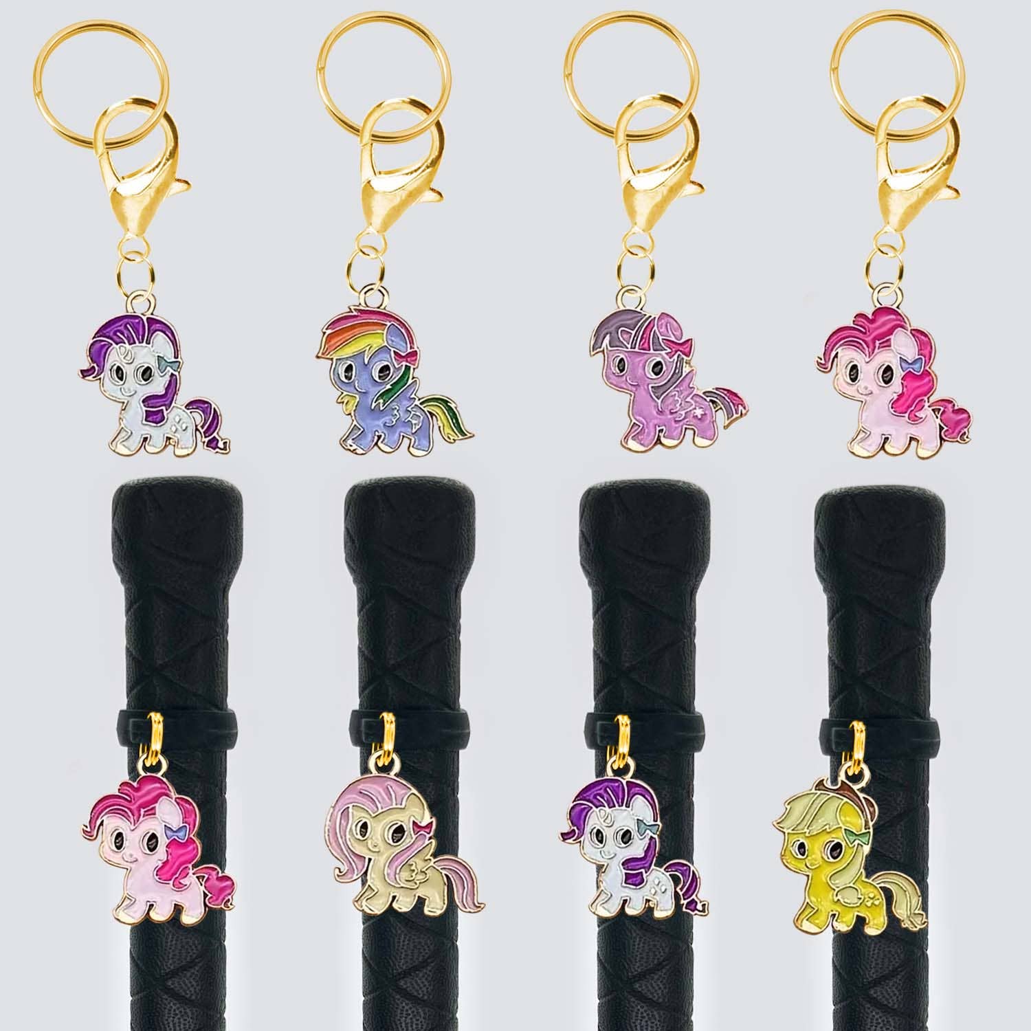 Set of five pony-shaped keychains on black hair ties against a white background