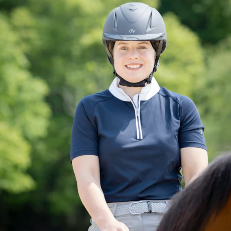 Person riding a horse wearing equestrian attire and helmet.