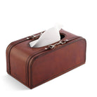 Brown leather tissue box with white tissues on a white background