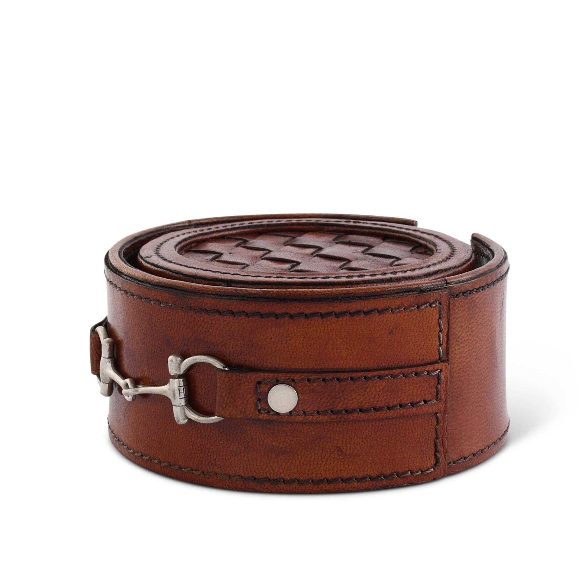 Brown leather coaster set with silver buckle on a white background