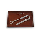 Two silver letter openers on a wooden tray with a white background