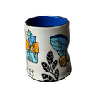 White mug with colorful designs on a gray background