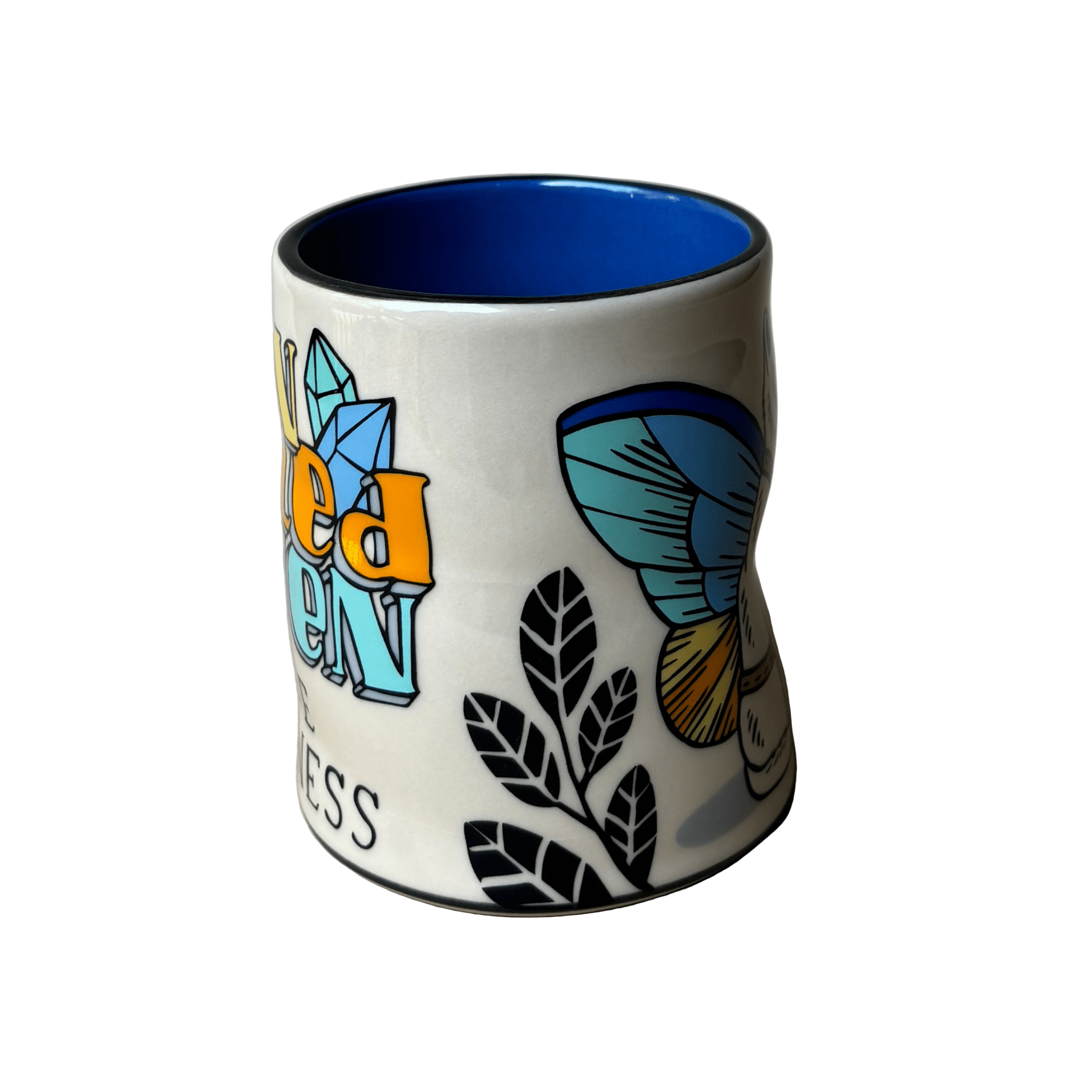 White mug with colorful designs on a gray background