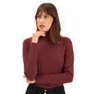 A woman wearing a long-sleeve, high-neck turtleneck top in a deep burgundy or maroon color, featuring the brand name 'DADA' printed on the lower cuff. She is posing against a solid white background.