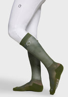 Green knee-high socks with a brand logo on a white background