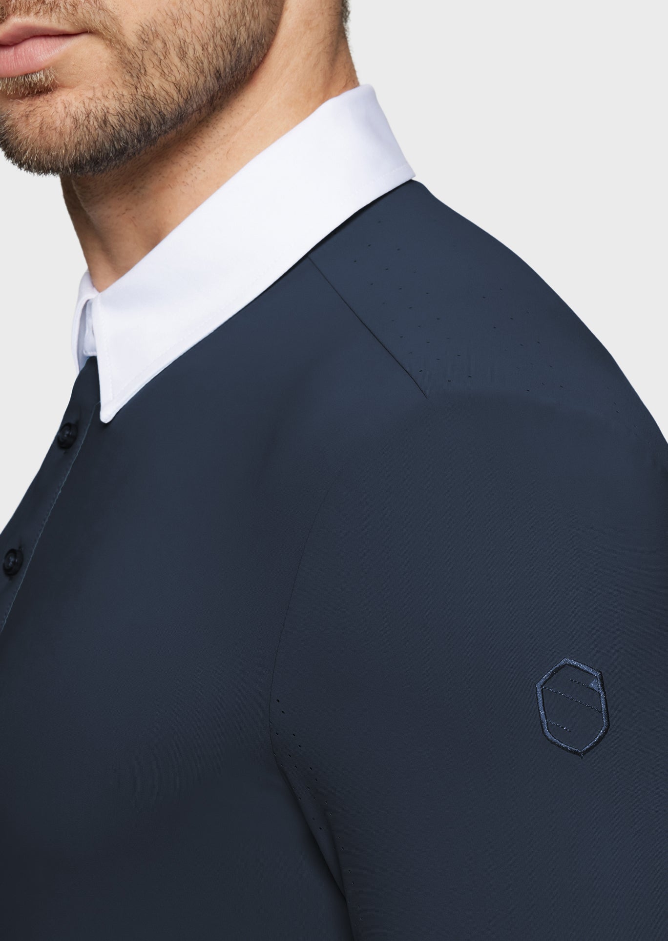 Navy suit jacket with white shirt collar on a plain background