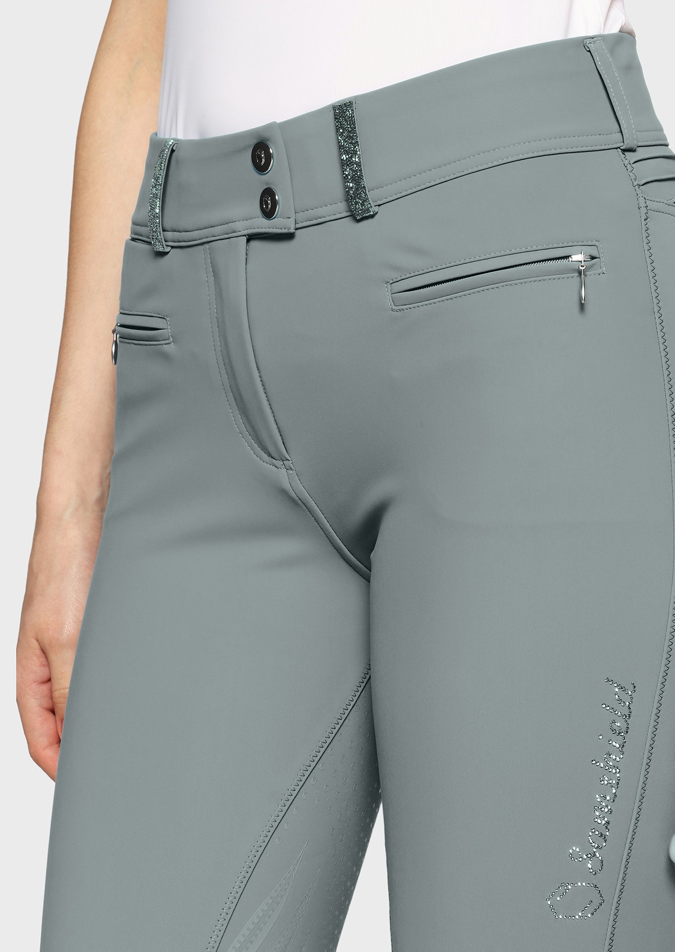 Gray riding pants with a brand logo on a white background