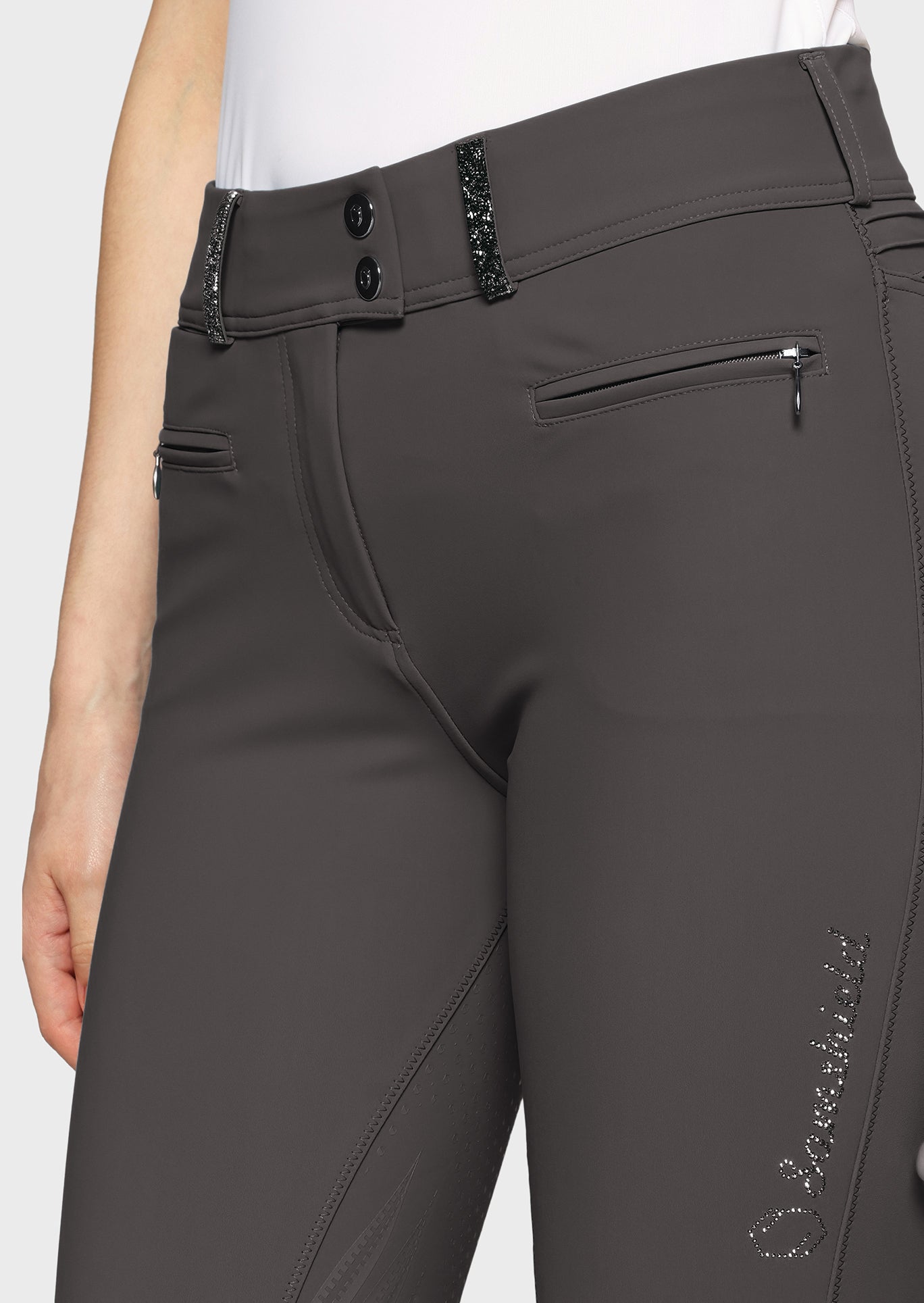Gray riding pants with a brand logo on a white background