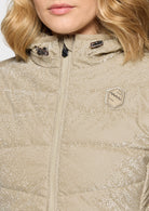 Close-up of a beige quilted jacket with a brand logo on a white background