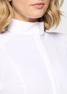 Close-up of a person wearing a white shirt with a collar.