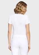 Person wearing a white outfit on a plain background