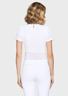 Woman wearing a white outfit on a plain background