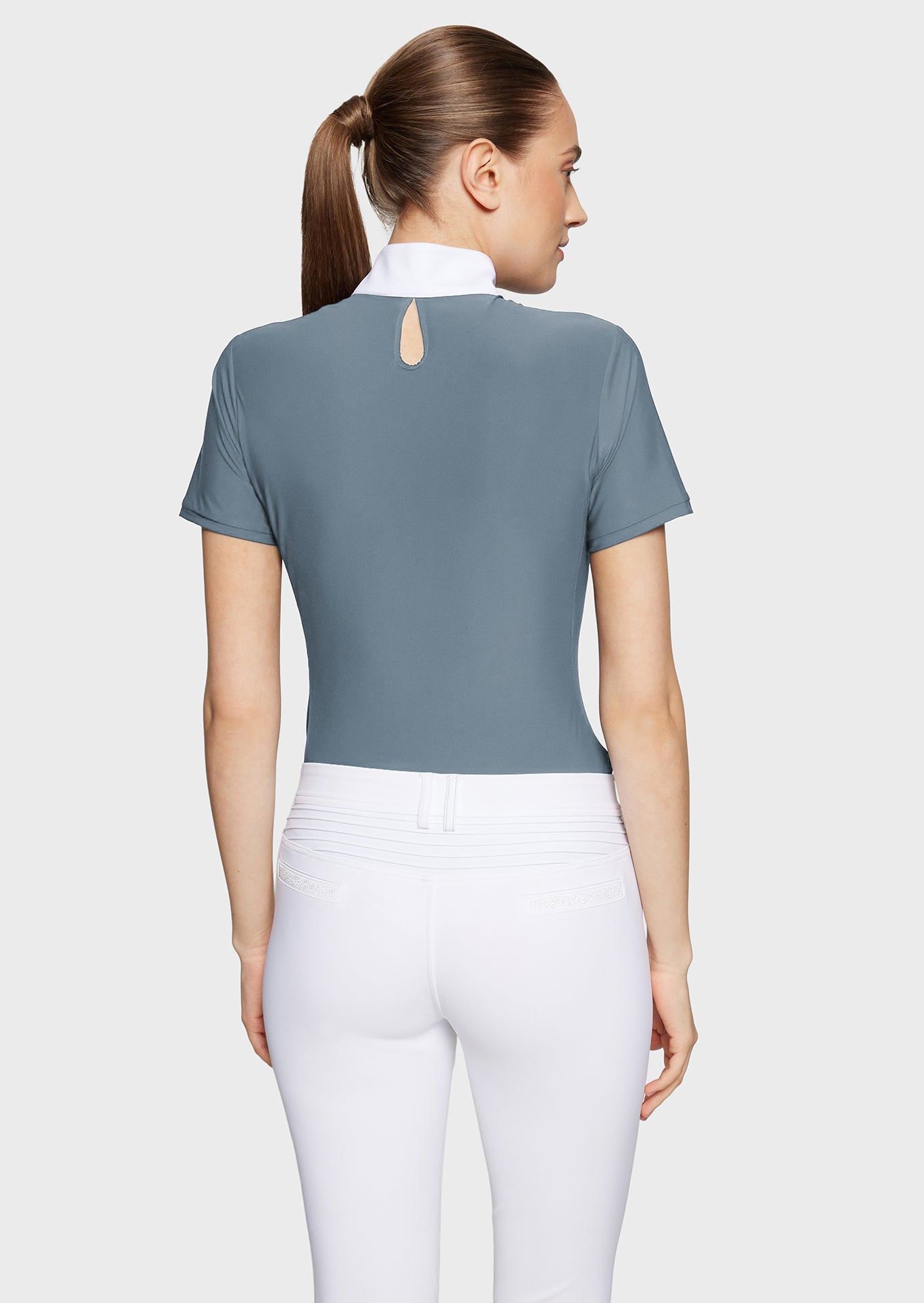 Woman wearing a gray short-sleeve top with a cut-out back design on a white background