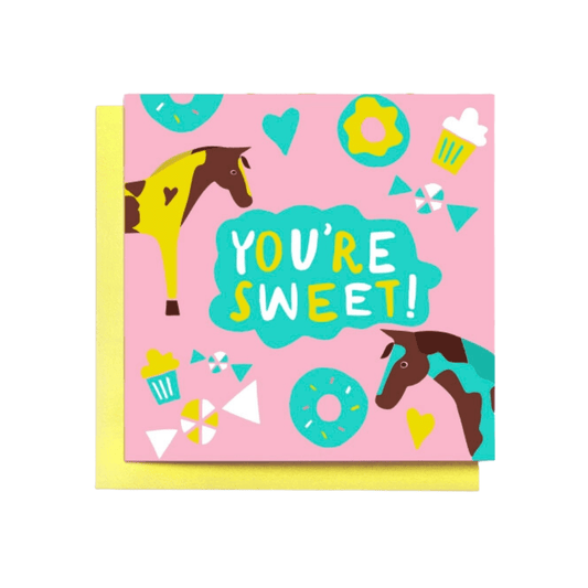 Card with text, "You're Sweet!" Image: pink background with yellow/brown paint horse and blue/brown paint horse. Cupcakes, donuts, candy, and hearts.