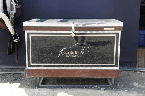 Horse equipment storage box labeled 'Absolute Hunter Jumpers.'