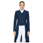 A woman modeling a navy blue double-breasted equestrian-style riding coat over a white shirt and white breeches, photographed against a plain white studio background.