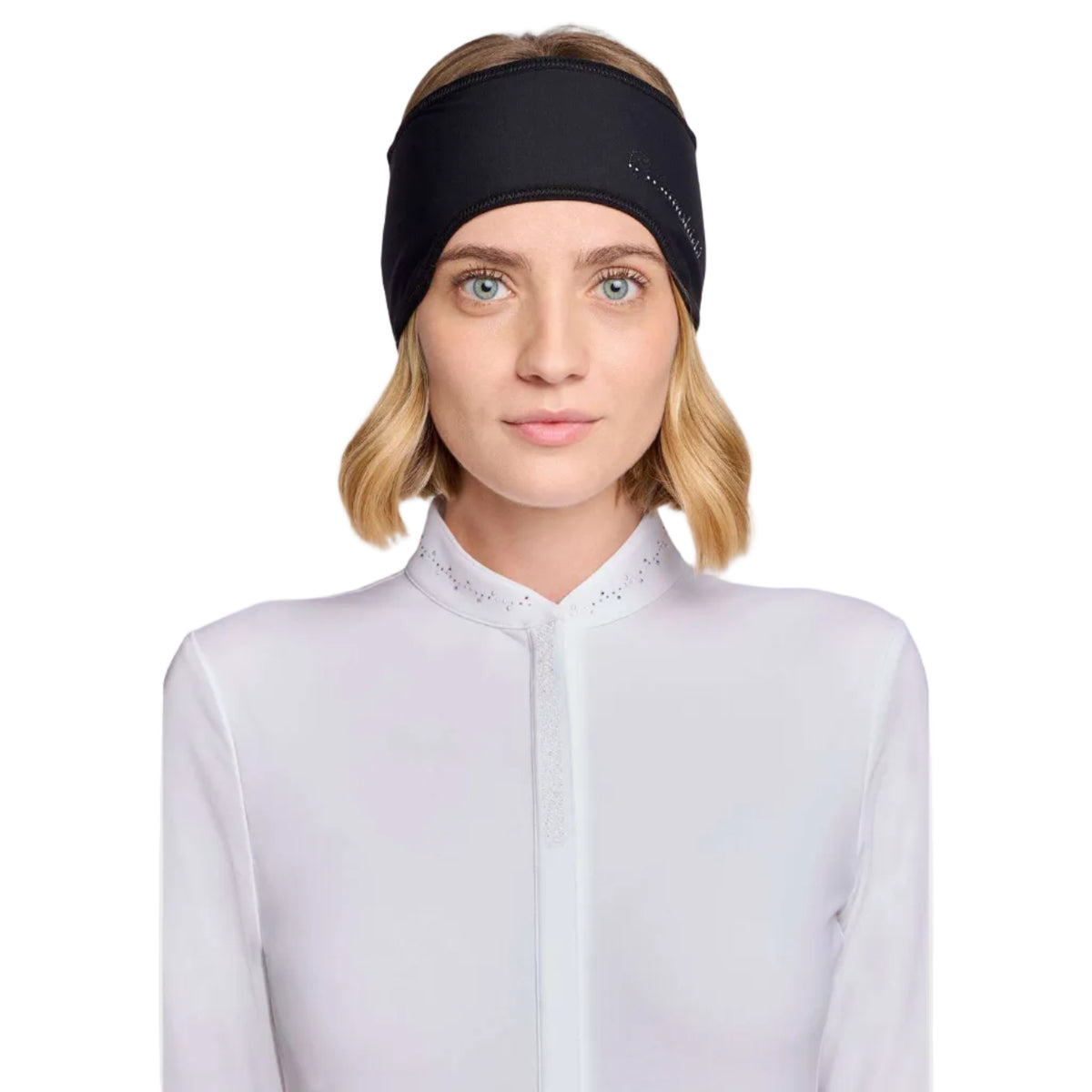 A woman with blonde hair wearing a black athletic headband and a white high-neck top, photographed against a light gray studio background.