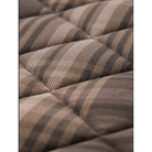Close-up of a quilted fabric surface with a plaid pattern in beige, taupe, and dark brown.