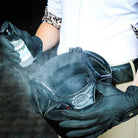A person spraying a helmet with 'noggin. A Fresh Helmet Spray' to freshen and clean it.