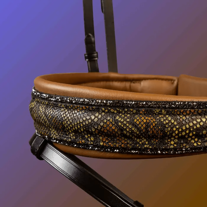 Decorative leather headpiece with a reptile skin pattern on a gradient background.