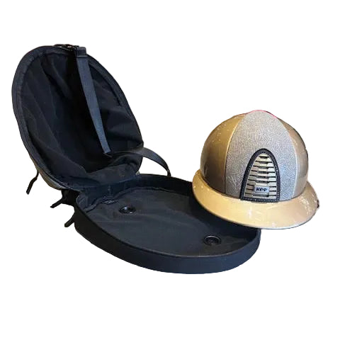A silver glitter equestrian riding helmet with a beige brim sits next to its open black hard carrying case on a concrete floor in a store.