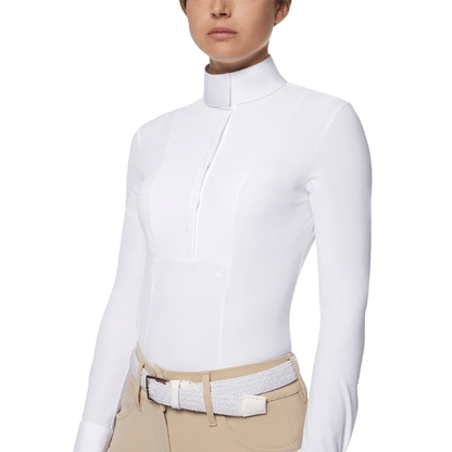 Front torso view of lady wearing long sleeve, white show shirt with tan breeches & white belt. 