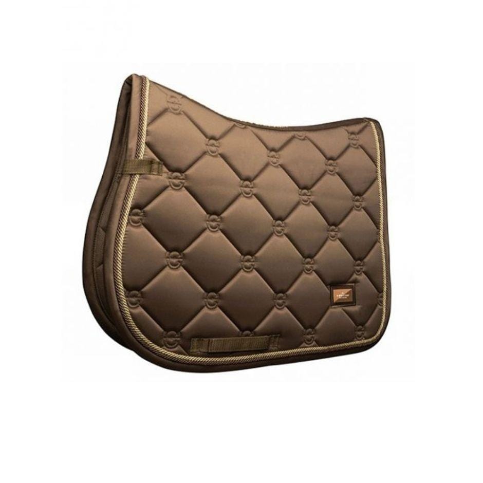 Close contact saddle pad in a champagne colored satin. Gold and brass cording borders the edges of the pad 